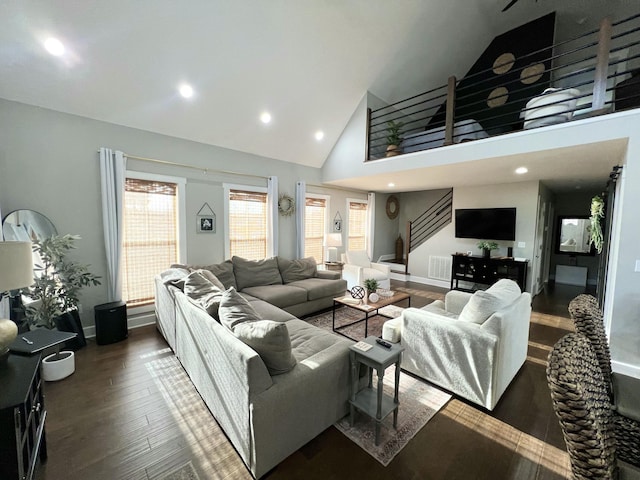 living room featuring dark wood-type flooring and high vaulted ceiling