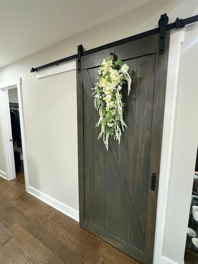 details featuring hardwood / wood-style flooring and a barn door