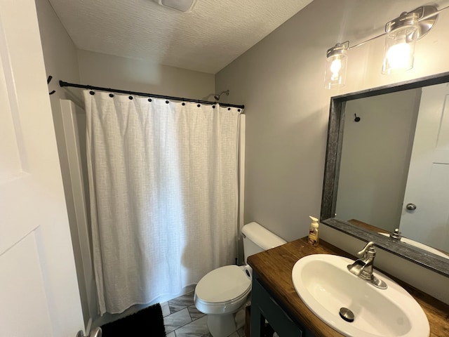 bathroom with vanity, curtained shower, a textured ceiling, and toilet