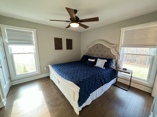 bedroom with dark hardwood / wood-style flooring, multiple windows, and ceiling fan