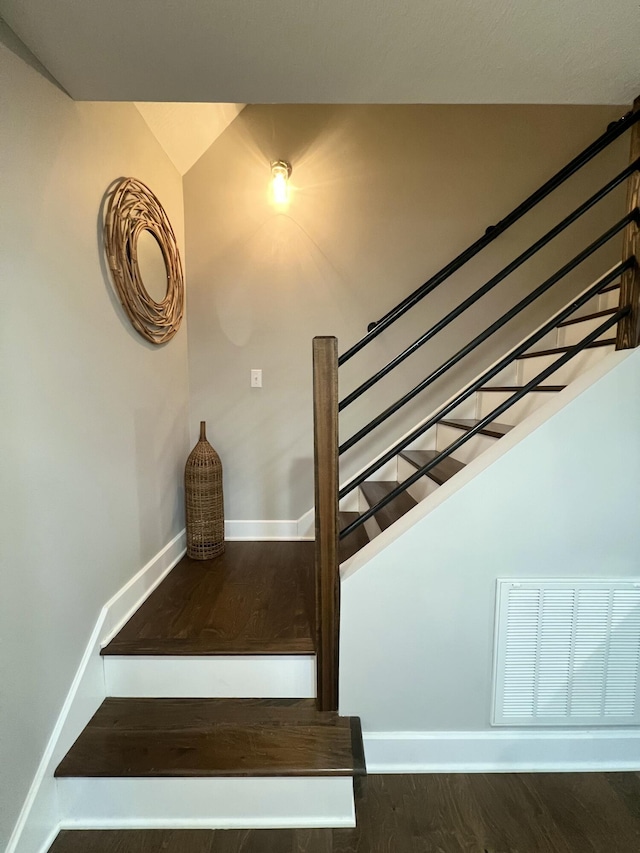 stairs featuring hardwood / wood-style flooring