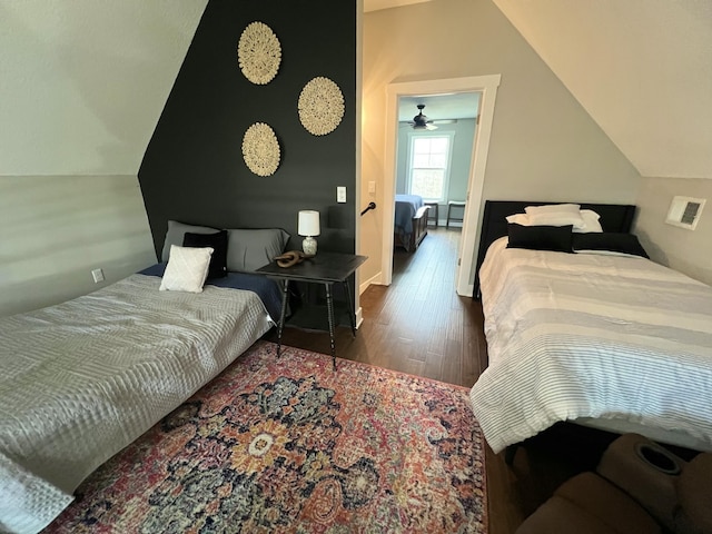 bedroom featuring lofted ceiling and dark hardwood / wood-style flooring