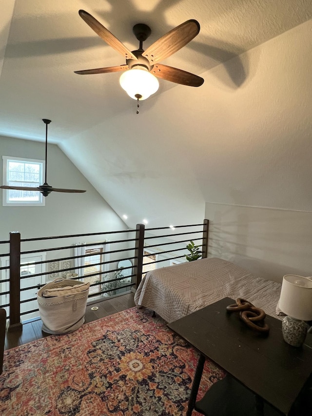 bedroom featuring hardwood / wood-style flooring, ceiling fan, and vaulted ceiling