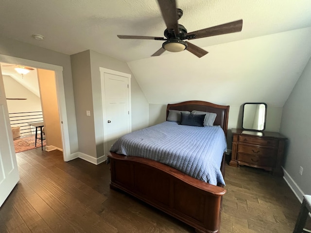 bedroom featuring lofted ceiling, dark wood-type flooring, and ceiling fan