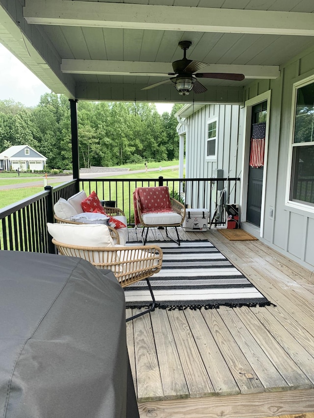 wooden deck featuring ceiling fan