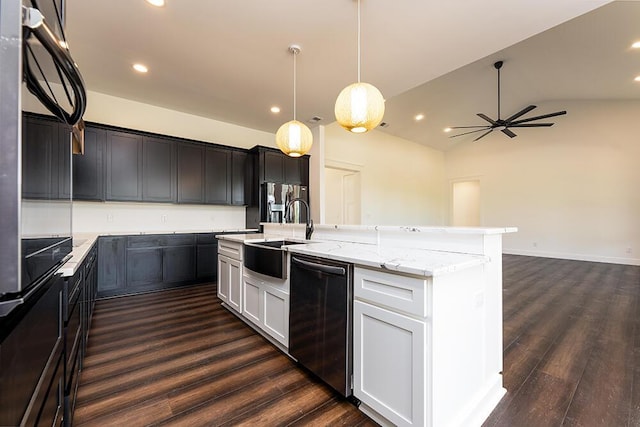 kitchen featuring sink, white cabinetry, decorative light fixtures, black dishwasher, and a kitchen island with sink