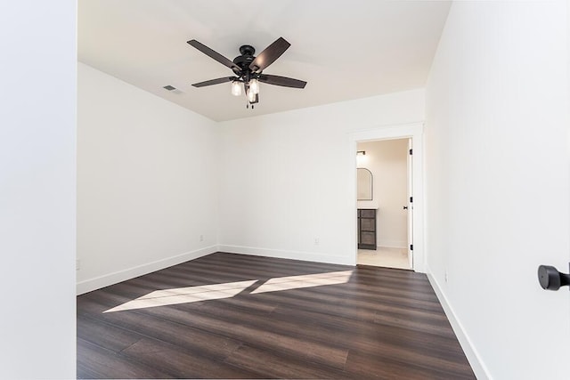 empty room with dark hardwood / wood-style flooring and ceiling fan