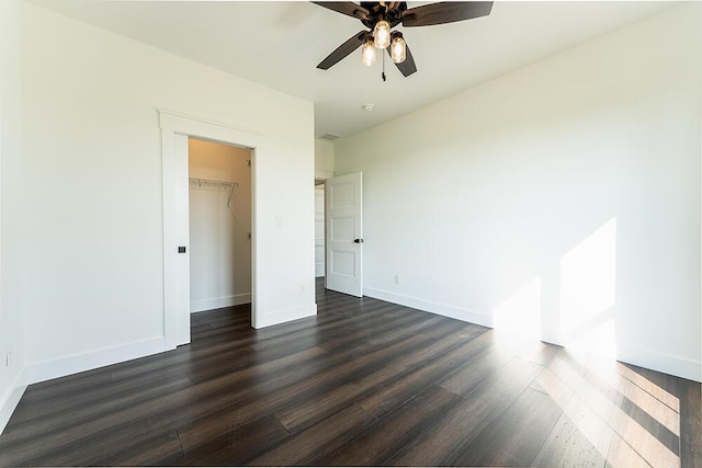 unfurnished bedroom featuring ceiling fan, dark hardwood / wood-style flooring, and a closet