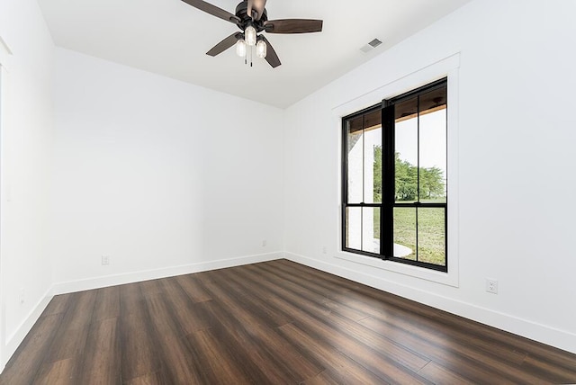 empty room featuring dark wood-type flooring and ceiling fan