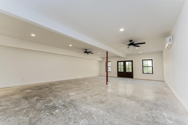 empty room featuring french doors, ceiling fan, a wall mounted air conditioner, and beam ceiling