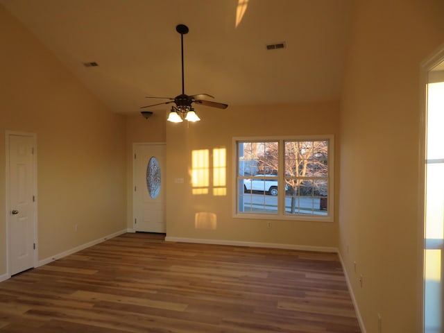 foyer featuring wood-type flooring, ceiling fan, and high vaulted ceiling