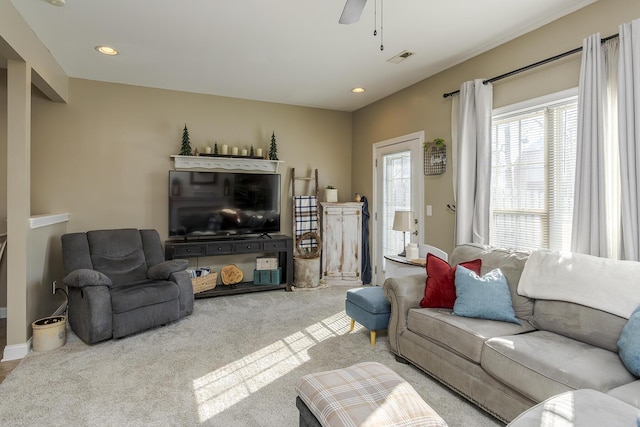 carpeted living room featuring a ceiling fan, visible vents, and recessed lighting