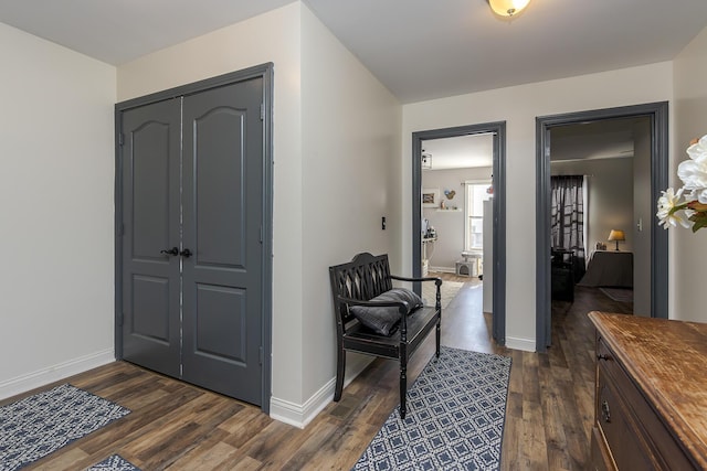 foyer with dark wood finished floors and baseboards