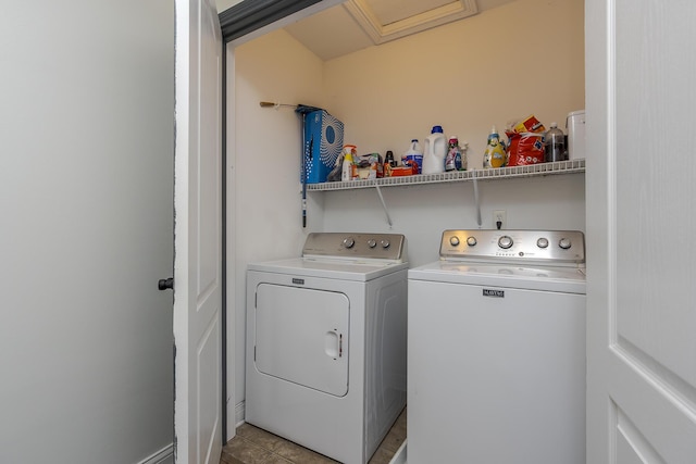 laundry room featuring washer and clothes dryer and light tile patterned flooring