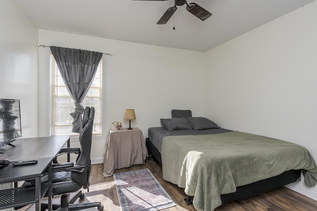 bedroom featuring ceiling fan, baseboards, and wood finished floors