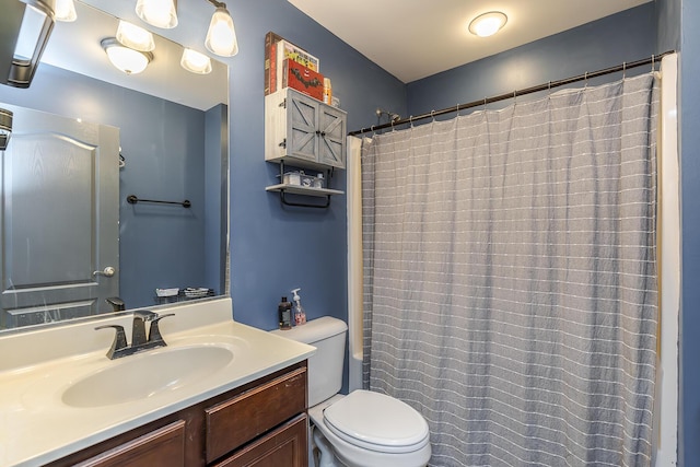 bathroom with vanity, toilet, and curtained shower