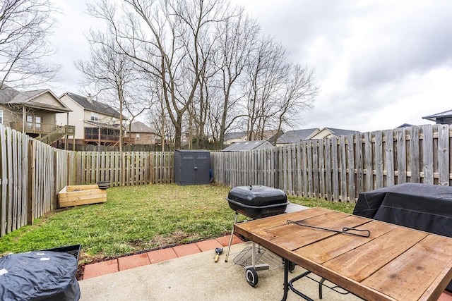 view of yard featuring outdoor dining space, a fenced backyard, a patio, and an outdoor structure