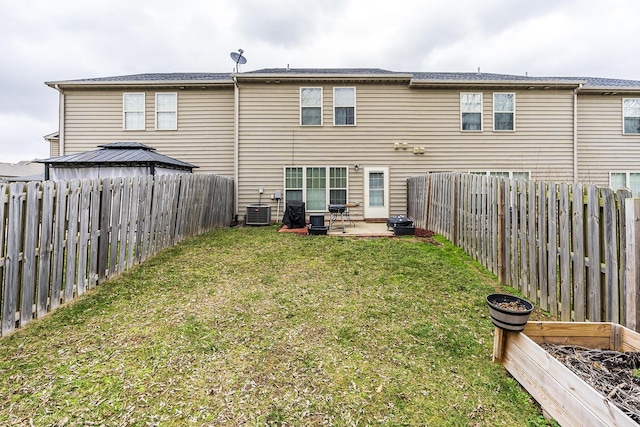 back of house featuring cooling unit, a fenced backyard, a lawn, and a patio