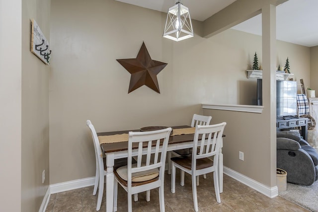 dining area featuring tile patterned flooring and baseboards