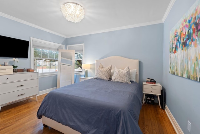 bedroom featuring ornamental molding, a chandelier, and hardwood / wood-style floors