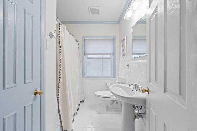 bathroom featuring sink, crown molding, tile walls, tile patterned flooring, and toilet