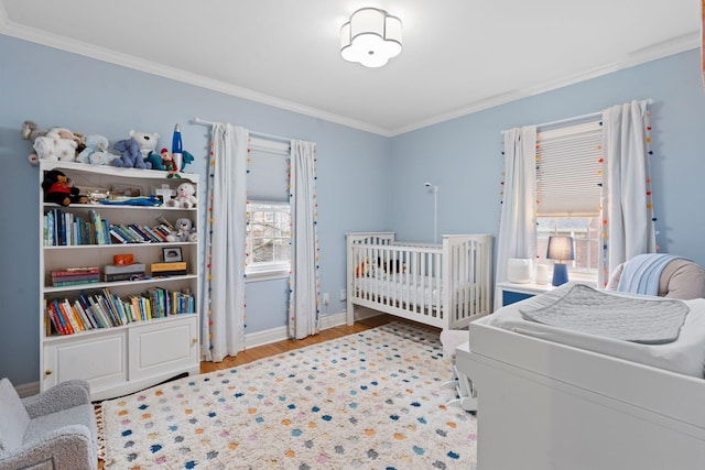 bedroom with multiple windows, crown molding, and light wood-type flooring