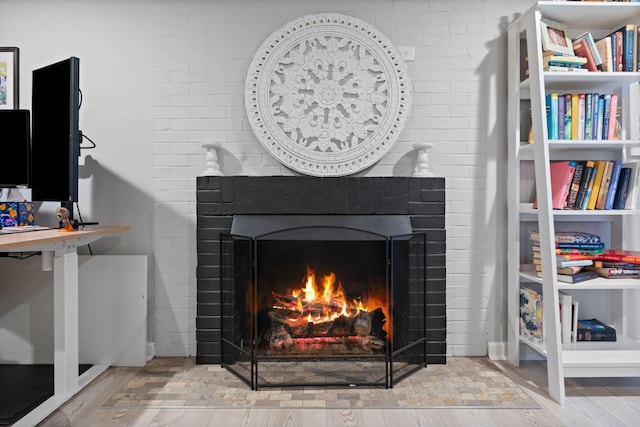 room details featuring hardwood / wood-style flooring and a large fireplace