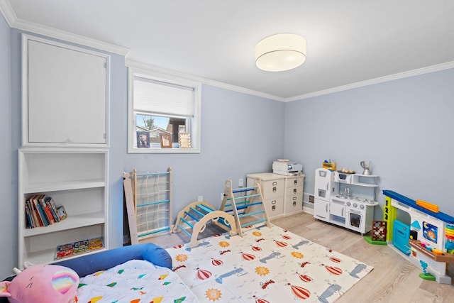 bedroom with crown molding and light wood-type flooring