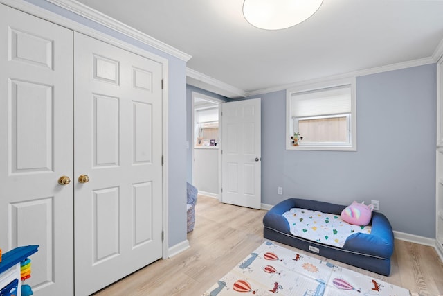 bedroom with ornamental molding and light hardwood / wood-style flooring