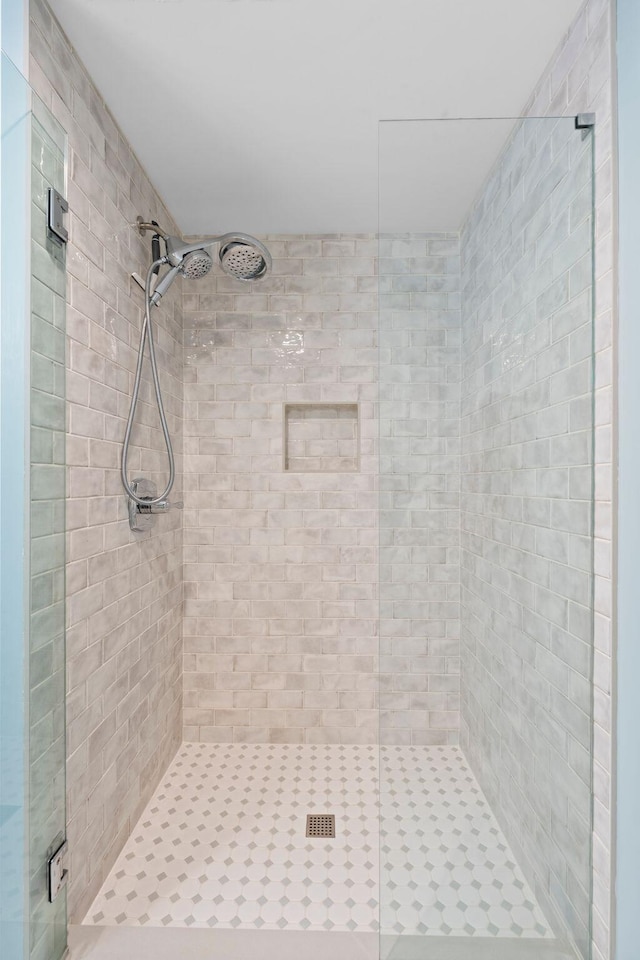 bathroom with a shower with shower door