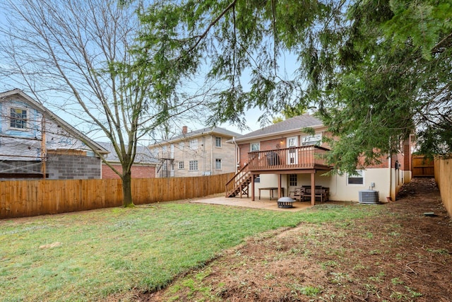 view of yard featuring a wooden deck, central AC unit, a patio area, and an outdoor fire pit