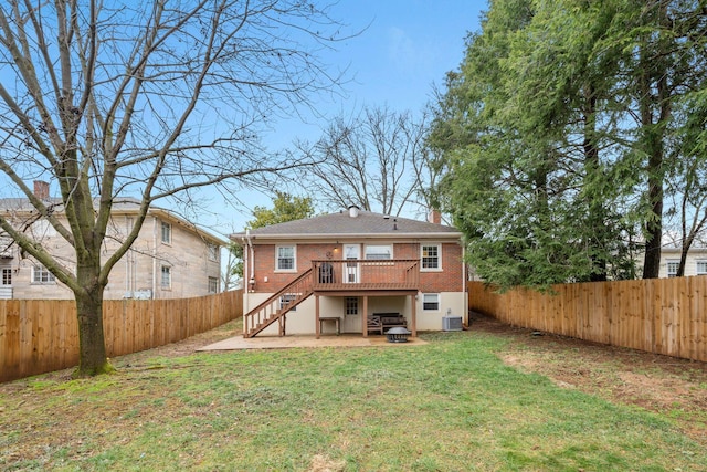 back of property featuring a wooden deck, a yard, a patio area, and central AC unit