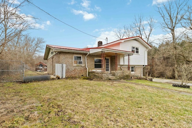 rear view of house with cooling unit, covered porch, and a lawn