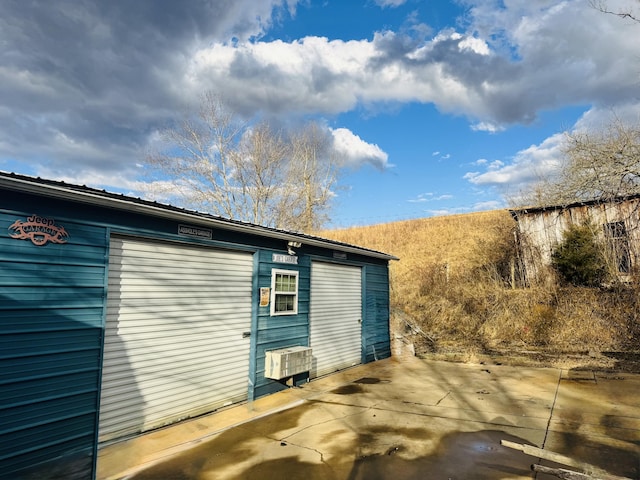 view of side of property with an outbuilding and a garage