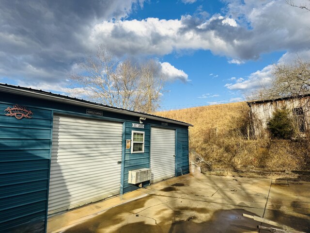 view of home's exterior featuring an outbuilding and a garage