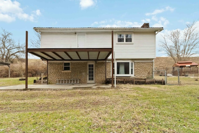 back of house with a patio area and a lawn