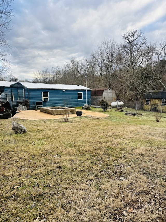 rear view of property featuring a patio area and a lawn