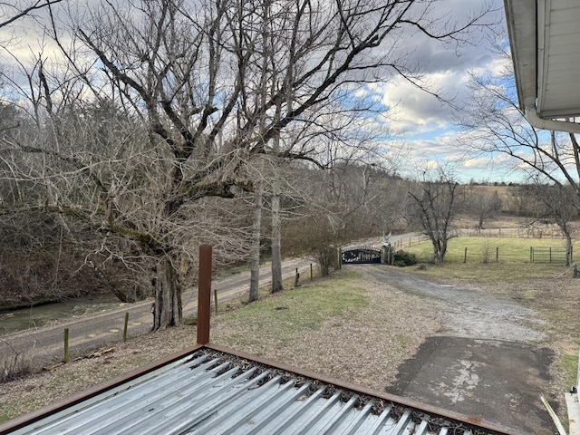 view of yard with a rural view