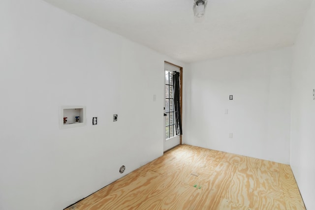 interior space featuring hookup for a washing machine, light hardwood / wood-style flooring, and hookup for an electric dryer