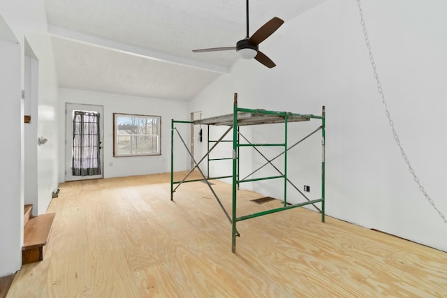 additional living space featuring lofted ceiling with beams, hardwood / wood-style floors, and ceiling fan