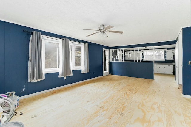 unfurnished living room with ceiling fan and light hardwood / wood-style flooring