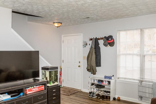 interior space with hardwood / wood-style flooring and a textured ceiling