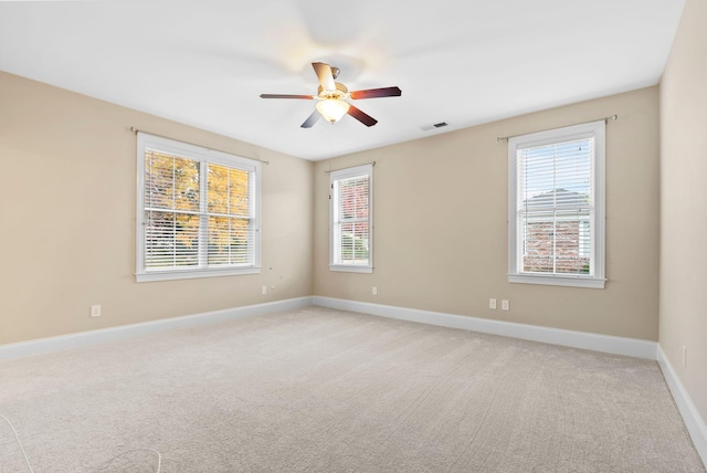 empty room with light colored carpet and ceiling fan