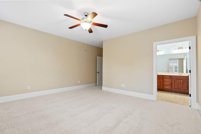 unfurnished bedroom with light carpet, connected bathroom, and ceiling fan