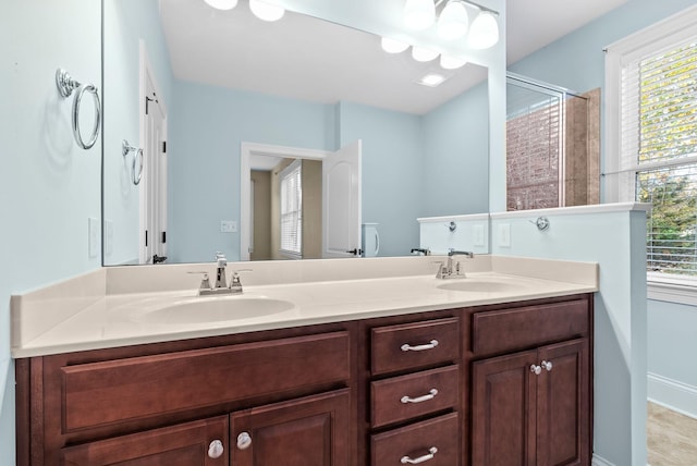 bathroom featuring an enclosed shower and vanity