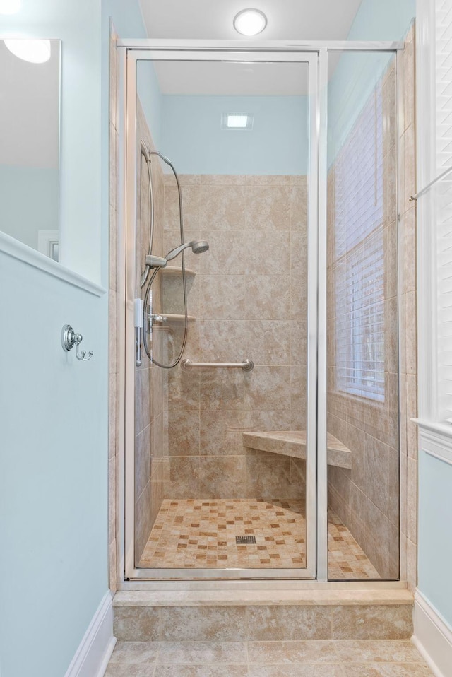 bathroom with a shower with shower door