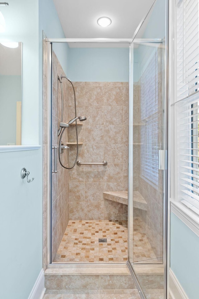 bathroom featuring a shower with shower door