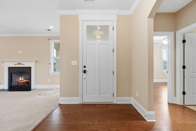 foyer entrance featuring ornamental molding and hardwood / wood-style floors