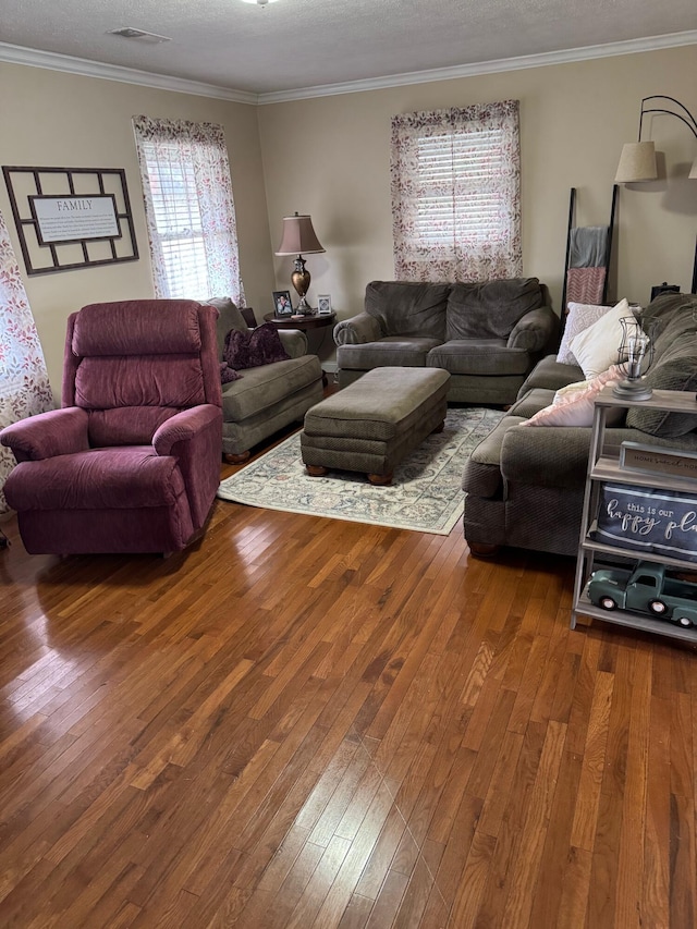 living room with ornamental molding, hardwood / wood-style floors, and a textured ceiling