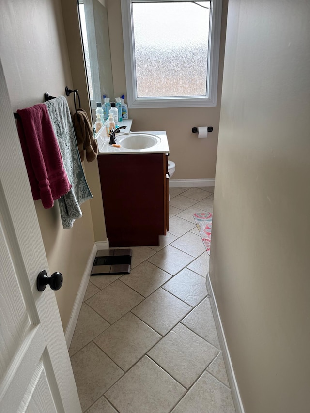 bathroom with tile patterned floors, vanity, and toilet